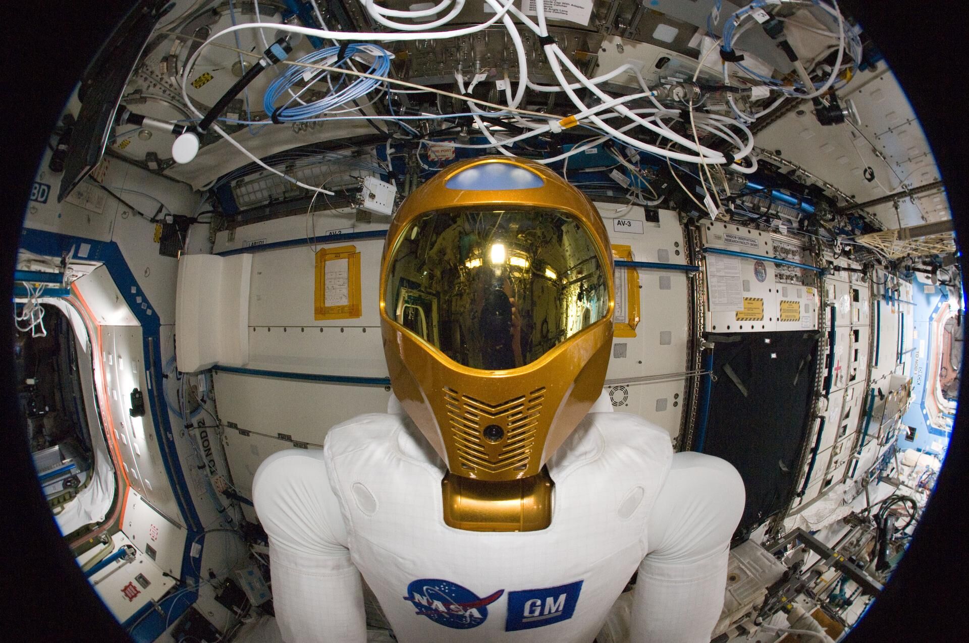 A fisheye lens attached to an electronic still camera was used to capture this image of Robonaut 2 humanoid robot during another system checkout in the Destiny laboratory of the International Space Station. Teams on the ground commanded Robonaut through a series of dexterity tests as it spelled out ?Hello world? in sign language.