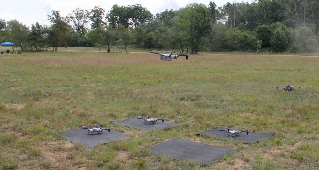 An unmanned aerial system or “Drone” hovers during take-off, to join a “SWARM” of “Drones” at Northern Strike 26-2 in the “Field of Drones,” a UAS and Counter-UAS Controlled Airspace Geospatial Environment or “CAGE” at Camp Grayling, Mich., Aug. 8, 2026. (Photo Credit: Master Sgt. Matthew Chlosta)